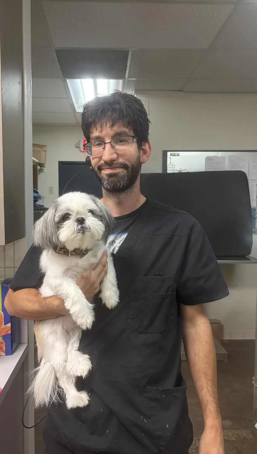 Joseph, your Houston pet sitter, holding a small dog